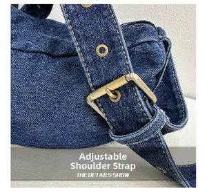 Detail of adjustable denim strap with vintage bronze buckle and reinforced metal eyelets
