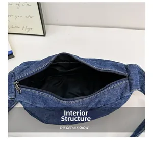 Internal view of blue denim tote bag showing zipper closure and black fabric lining