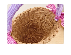 Detail view of woven straw basket featuring a purple plaid bow and spiral weave pattern