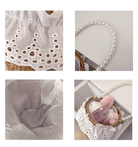 Close-up of handmade straw bucket bag with delicate white lace and pearl handle texture