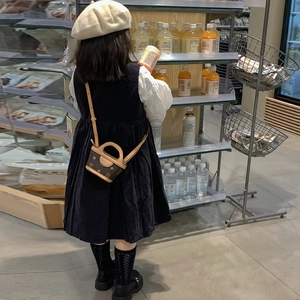 Classic monogram kids mini tote bag with crossbody strap shown in a real-life setting