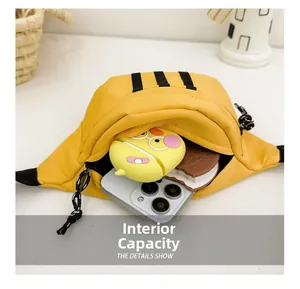 Detailed view of yellow canvas waist bag showing internal capacity with phone and case