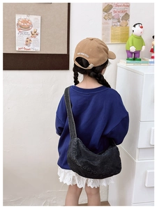 Kid's vintage denim half-moon crossbody bag in washed dark grey styled with casual wear