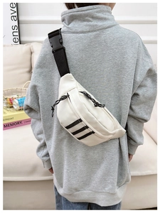 Close-up of nylon sports chest bag with iconic three stripes and adjustable buckle