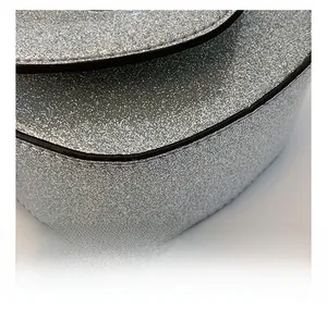 Macro shot showing premium black stitching details on silver glitter material of the bag