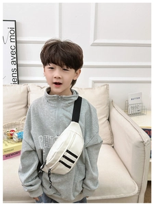Detail of white nylon kids chest bag featuring classic black stripes and adjustable strap