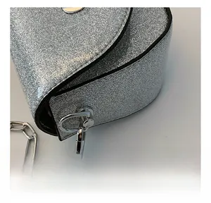 Detail of silver sequin bag showing high-quality metal D-ring hook and thick chain strap