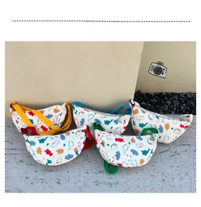 Close-up of kids dinosaur print canvas chest bags with colorful adjustable straps