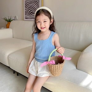Kids summer knit hollow sleeveless top and white shorts set with a straw bag