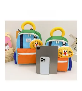 Size comparison of kindergarten backpacks in blue and orange with lion charm and tablet