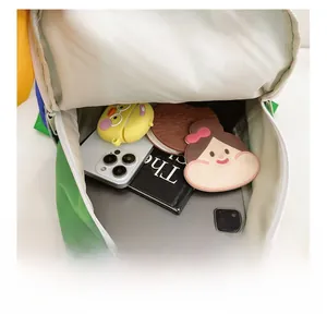 Internal view showing large storage capacity for books and tablets in green backpack