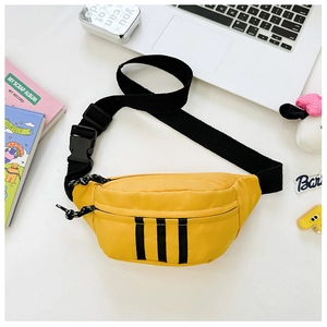 Macro view of bright yellow nylon sports chest bag with black stripes and adjustable strap