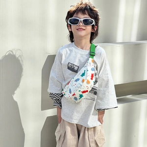 Kids dinosaur print crossbody bag with vibrant green strap and white canvas material