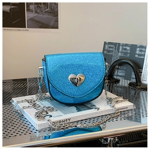 Close-up of blue sequin mini bag featuring a silver heart-shaped twist lock and chain