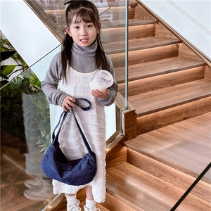Child in denim crescent tote bag on stairs showing retro dark blue shoulder bag style