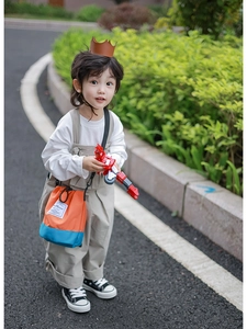 Close-up of kids bucket bag with orange and blue contrast colors and drawstring detail