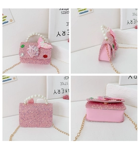 Detail view of pink sequin shell-themed girl's handbag with pearl handle and chain