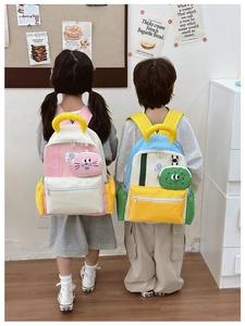 Detail of color-block kindergarten backpacks with cute animal pendants on models