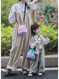 Detail view of two-tone bucket bags with drawstring closure and adjustable strap