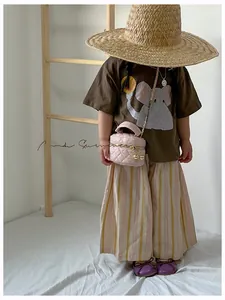 Détail d'un mini sac matelassé rose pour enfant avec bandoulière chaîne dorée