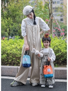 Matching parent and child bucket bags in trendy colorblock design with fashion labels