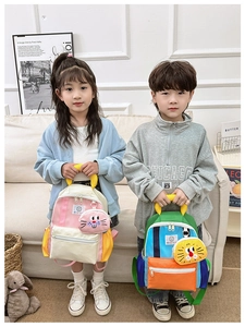 Kids color-block backpacks in pink and blue shown with cute cartoon coin purses