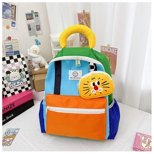Detail of color-block kids backpack with cute lion charm and durable nylon texture