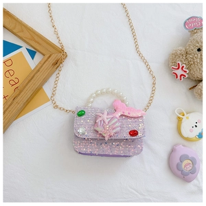 Detail of purple sequin mermaid bag with pearl handle and starfish seashell ornaments