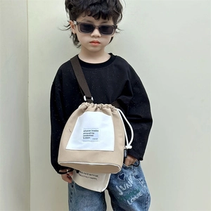 Kids minimalist khaki canvas crossbody bag with white pocket and drawstring closure