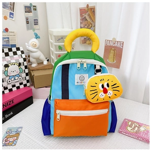 Detail of colorful nylon kids backpack with a cute yellow lion coin purse attachment