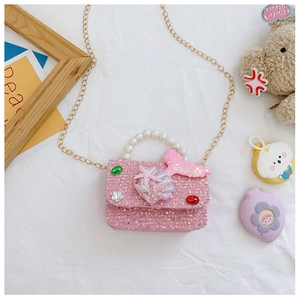 Detailed view of pink sequin girl bag with pearl handle and 3D mermaid tail decor
