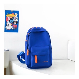 Detail of royal blue nylon chest bag featuring orange zippers and fashion lettering