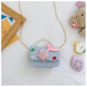Detail view of blue sequin girls purse with pearl handle and pink mermaid tail decoration