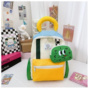 Detail of colorful kids backpack featuring a cute green cactus pendant and smile patch