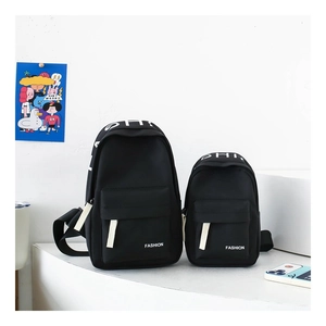 Detail of two black nylon chest bags in different sizes with white fashion lettering