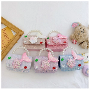 Detail of sequin kids handbags with shell decor and pearl handles in multiple colors