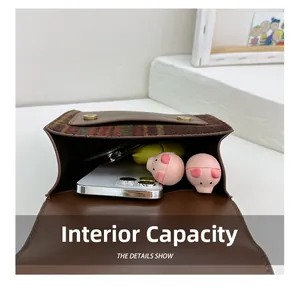 Detail showing the internal storage capacity and magnetic snap closure of the kids bag