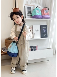 Children's drawstring bucket bags in vibrant color-block canvas with adjustable straps