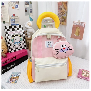 Detail of multi-color kids backpack with small cartoon coin purse and front pocket