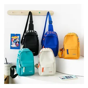 Close-up of colorful nylon kids chest bags in black blue yellow green and ivory white