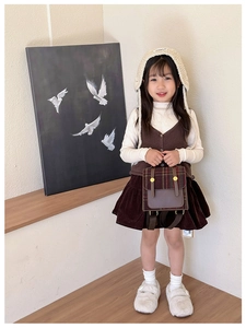 Miniature retro British style plaid backpack shown as a stylish accessory for children