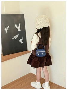 Girl's blue denim crossbody bag with quilted rhombic pattern and chain strap on model