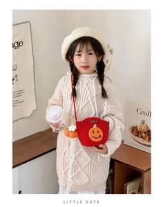 Girl carrying handmade red crochet pumpkin bag with warm knit sweater and beret