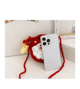 Handmade crochet Christmas Santa bag showing mini size compared to a smartphone