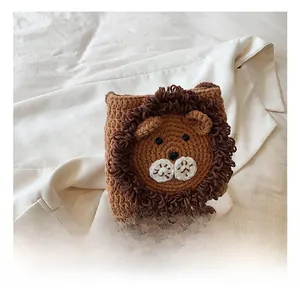 Detail showing handcrafted crochet lion bag with adorable cartoon facial features