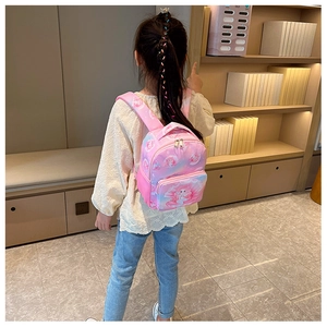 Girl's gradient pink purple backpack with cartoon mermaid print shown in use