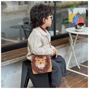 Kid's hand-knitted lion crossbody bag worn by a child in an outdoor setting