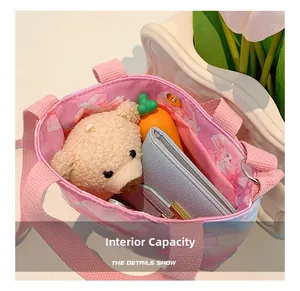 Internal view of the pink canvas tote bag showing storage space for toys and wallet