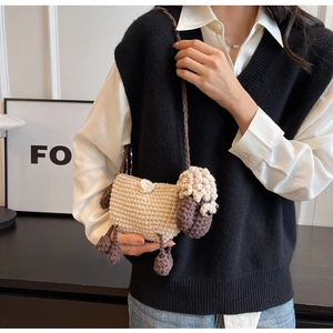 Detailed texture of handmade crochet sheep bag with beige body and brown knitted strap