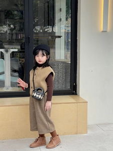 Close-up of a child wearing a stylish plaid mini bag with a chic autumn outfit set